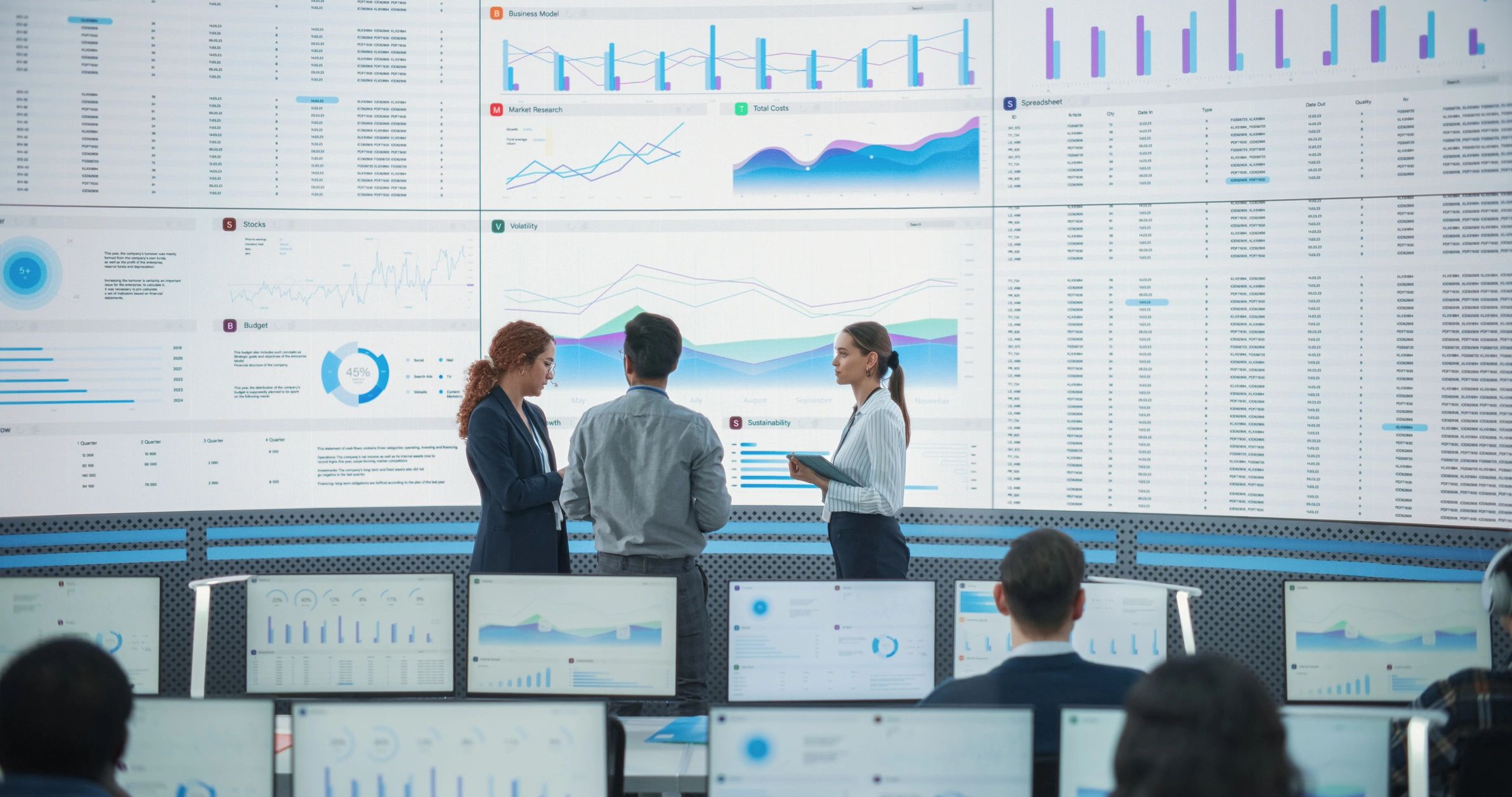 Cybersecurity team reviewing data on large monitoring screens